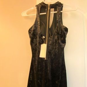 Black velvet fitted mini dress with an open zipper back and a choker collar